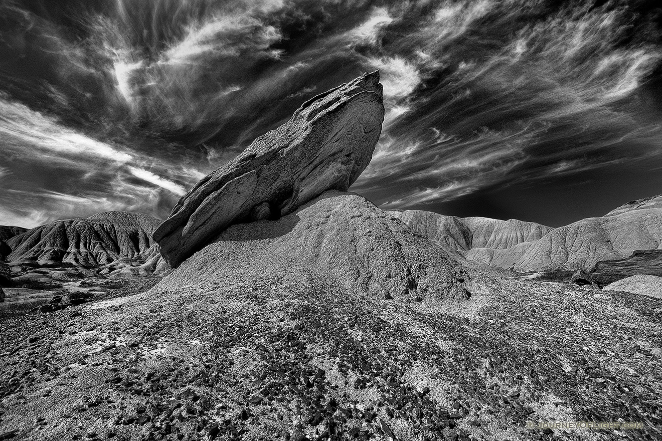 Wispy clouds float above a toadstool at Toadstool Geologic Park in Western Nebraska. - Toadstool Geologic Park Picture