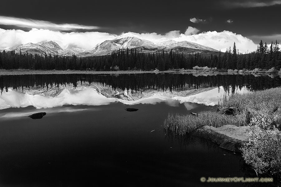 Just after a short storm rolled through, Red Rock Lake was still reflecting the mountains and clouds in the distance. - Colorado Photography