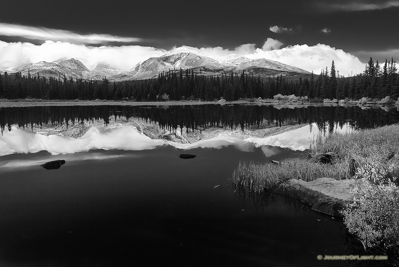 Just after a short storm rolled through, Red Rock Lake was still reflecting the mountains and clouds in the distance. - Colorado Picture