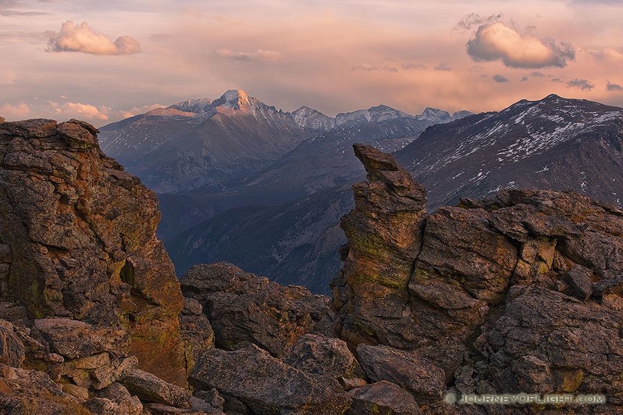 Longs peak is visible with the last light of the day through the rock cut on the alpine area of Rocky Mountain National Park. - Rocky Mountain NP Photography