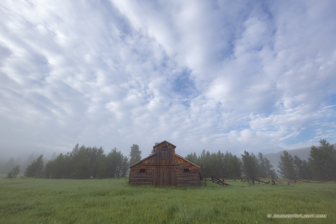 Fog engulfs the Kawuneeche Valley creating an eerie quiet near this old rustic barn in Rocky Mountain National Park. - Colorado Picture