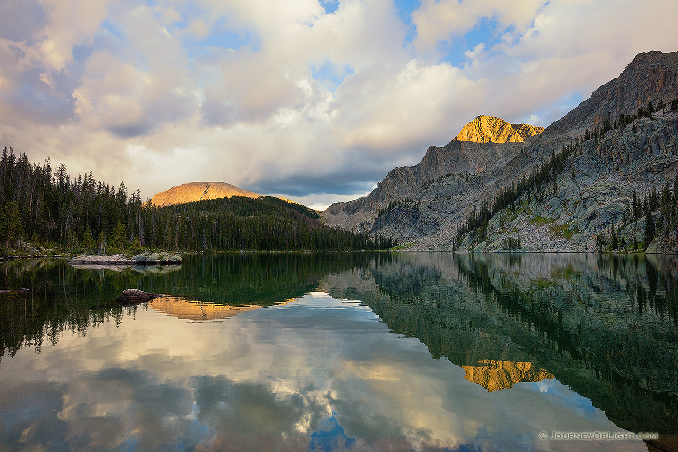 Mountains glow with the last light of a cool autumn day while an almost perfect reflection shimmers in Nanita Lake. - Colorado Picture