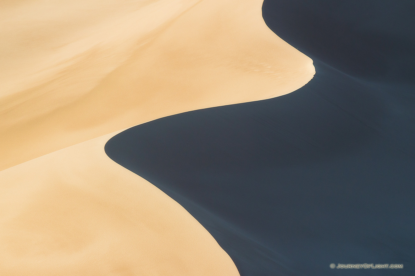 Morning sun streams across Great Sand Dune National Park and Preserve creating contrasts among the dunes. - Colorado Picture