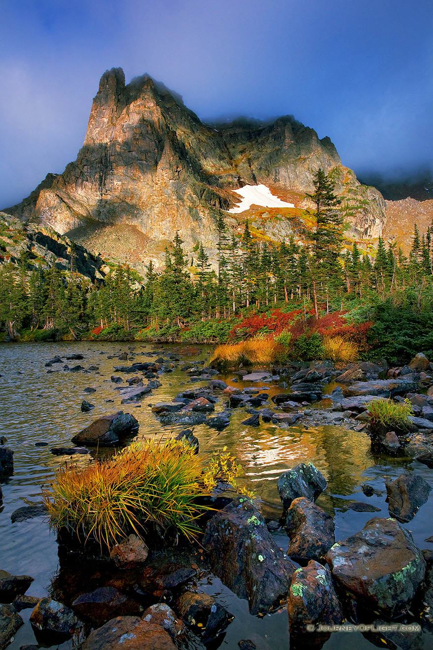 Light filters through the clouds during a short break in a rain storm that brought rain and sleet to Lake Helene. - Rocky Mountain NP Picture