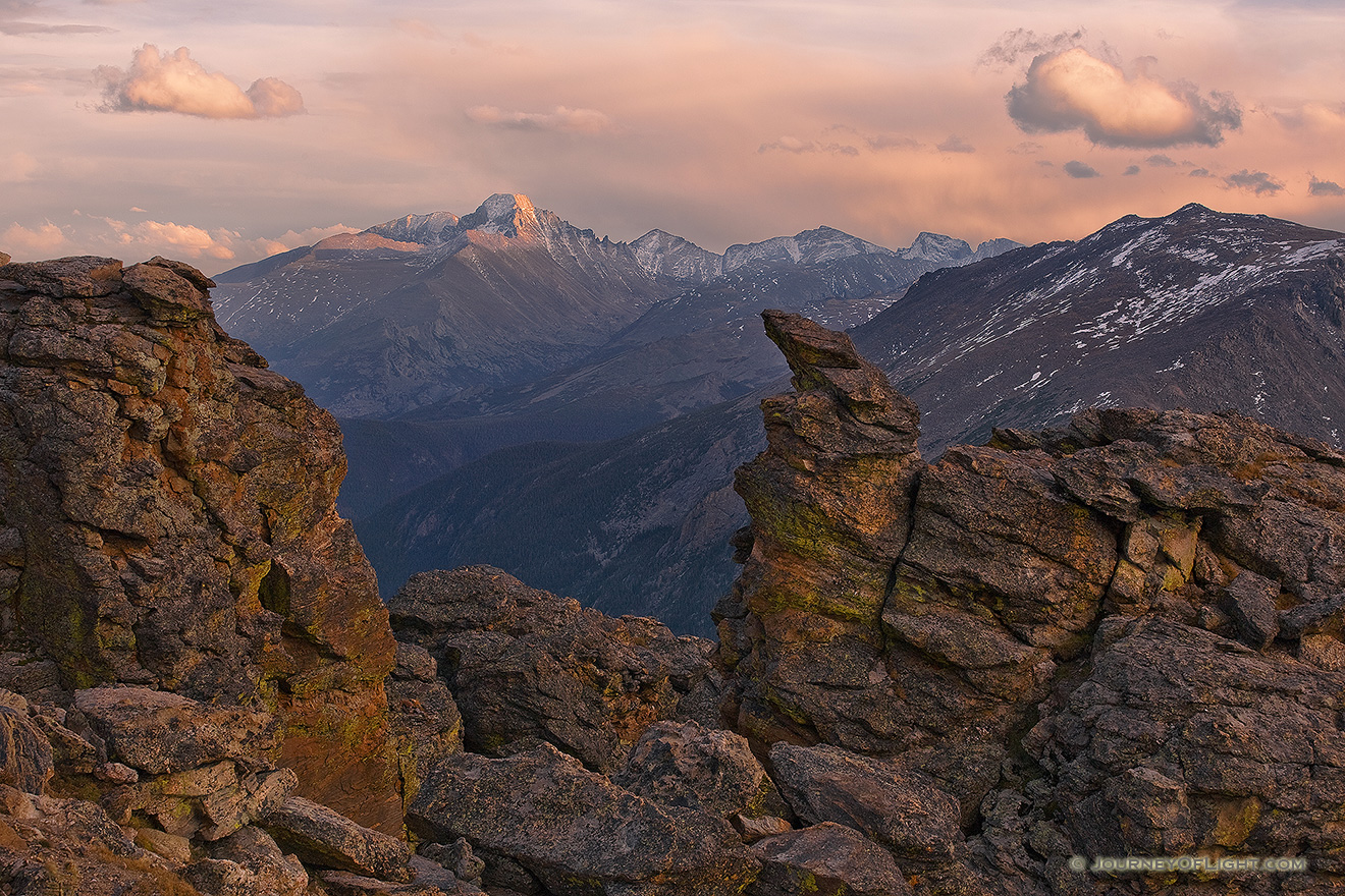 Longs peak is visible with the last light of the day through the rock cut on the alpine area of Rocky Mountain National Park. - Rocky Mountain NP Picture