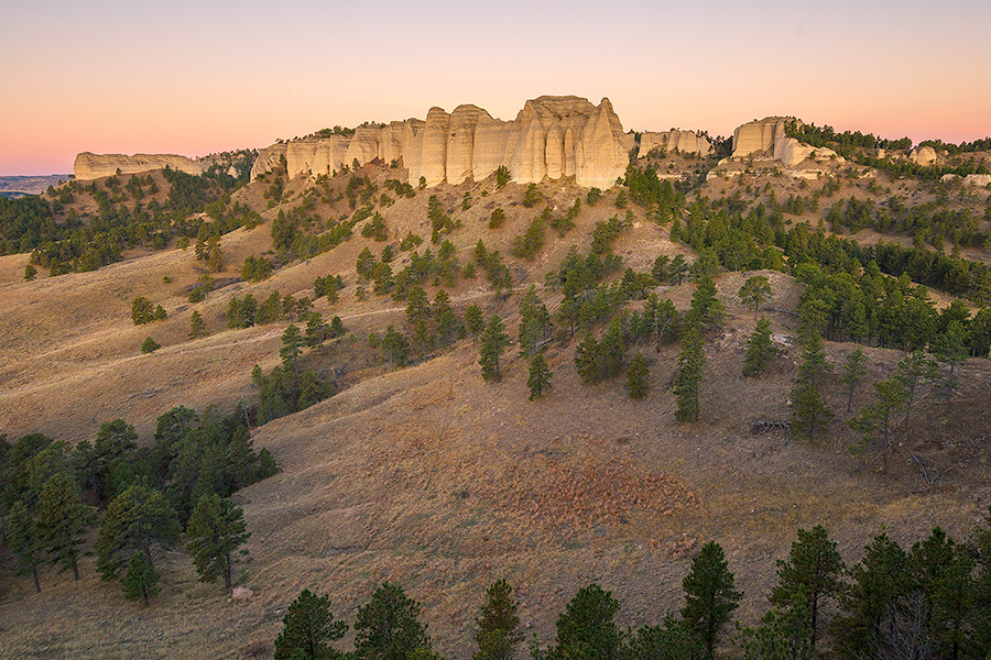 A scenic landscape photograph of the sunrise on the Red Cloud Buttes at Ft. Robinson in Northwestern Nebraska. - Nebraska Photography