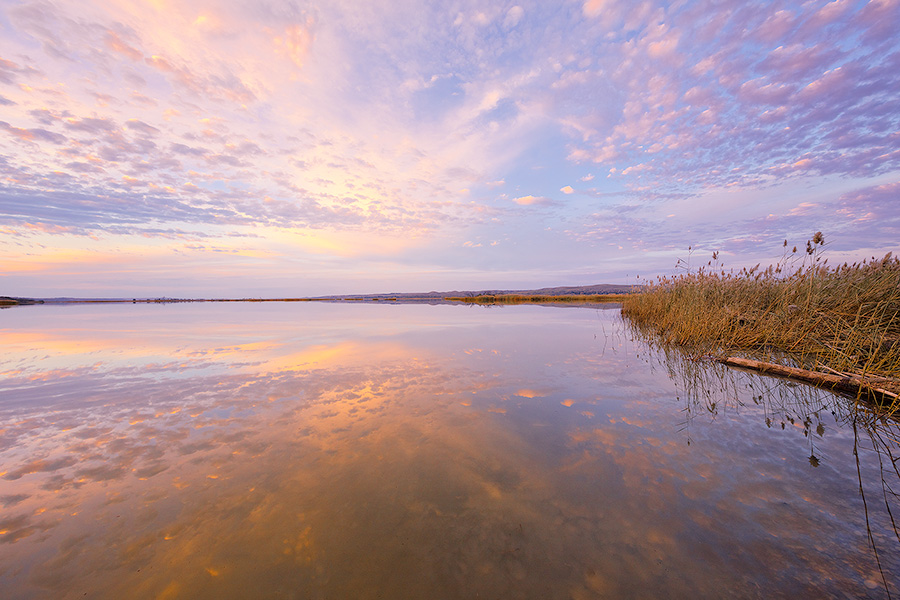 A beautiful sunset is reflected in the waters of the Missouri River at Niobrara State Park on the border of Nebraska and South Dakota. - Nebraska Photography