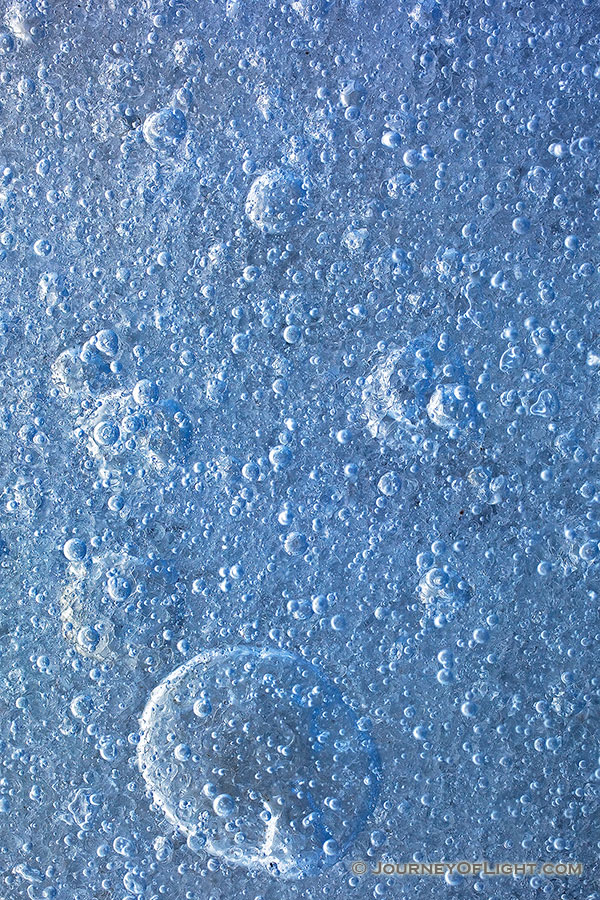 An abstract of bubbles formed in the frozen lake. - Nebraska Photography