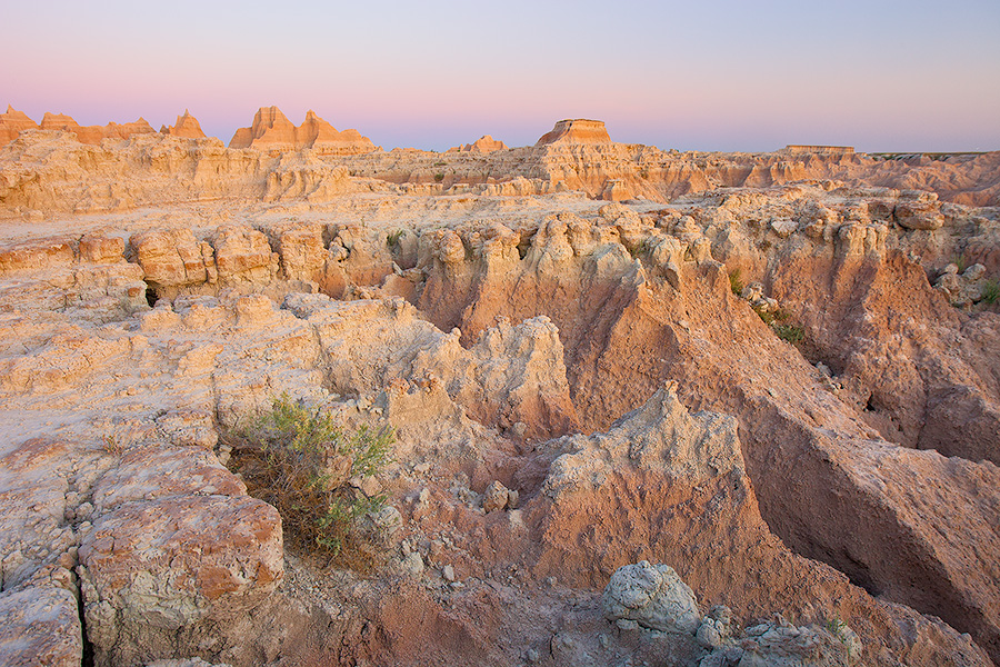 Warm sunlight hits the Badlands of South Dakota in Badlands National Park. - South Dakota Photography