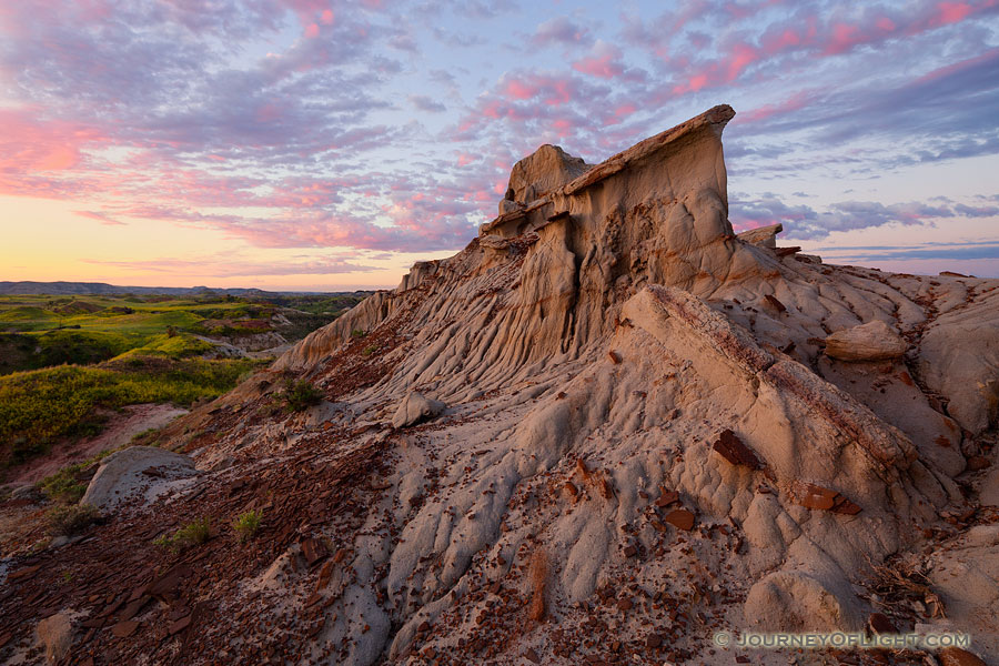 Clouds reflect the light of the rising sun across the High Plains in Theodore Roosevelt National Park. - North Dakota Photography