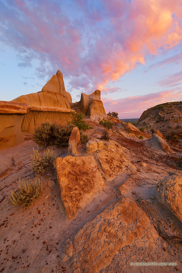 Clouds illuminated by the morning sun swirl above the badlands in western North Dakota in Theodore Roosevelt National Park. - North Dakota Photography