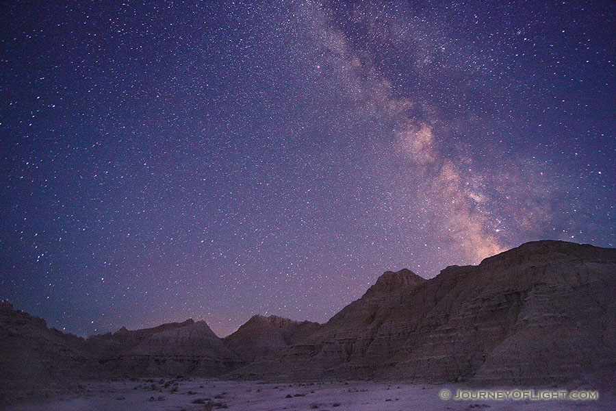 An arm of the Milky Way appears to flow out of the rocks at Toadstool Geologic Park in western Nebraska. - Toadstool Photography