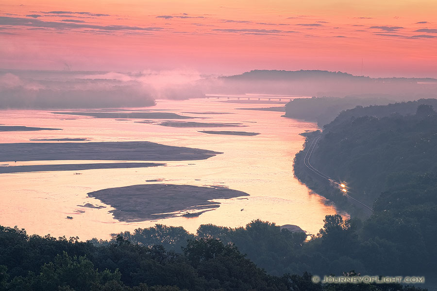 Morning fog hangs low across the Platte River and a train chugs down the tracks as seen from the tower at Platte River State Park. - Platte River SP Photography