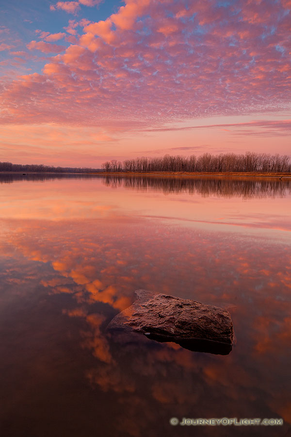 With nary a breeze and no other soul in sight, I enjoyed the vibrant colors brought forth from this sunrise in a quiet peacefulness and solitude. - Nebraska Photography