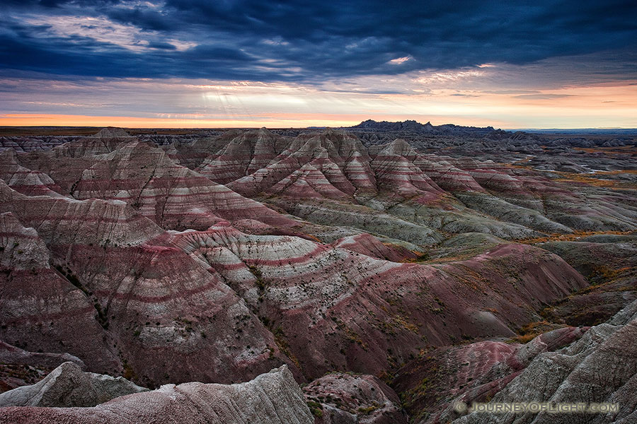 Early morning rays illuminate the Badlands in Badlands National Park, South Dakota.  Originally designated a National Monument, Badlands National Park was redesignated a National Park on November 10, 1978. - Badlands NP Photography