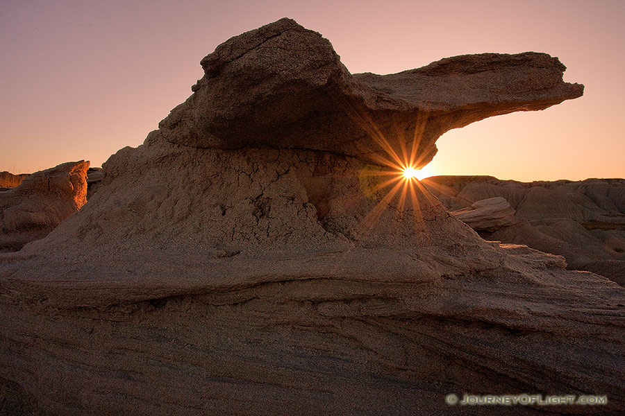 On a cool September evening, the final light of the setting sun pierces under one of the unique 'Toadstools' at Toadstool Geologic Park near Crawford. - Toadstool Photography