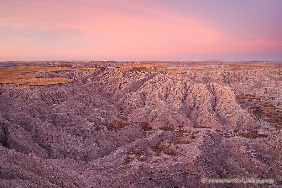 On a warm autumn evening from high on the plains, the last light of the day gives the canyons of the Oglala National Grassland just off the Hudson-Meng trail in western Nebraska a warm glow. - Nebraska Photography