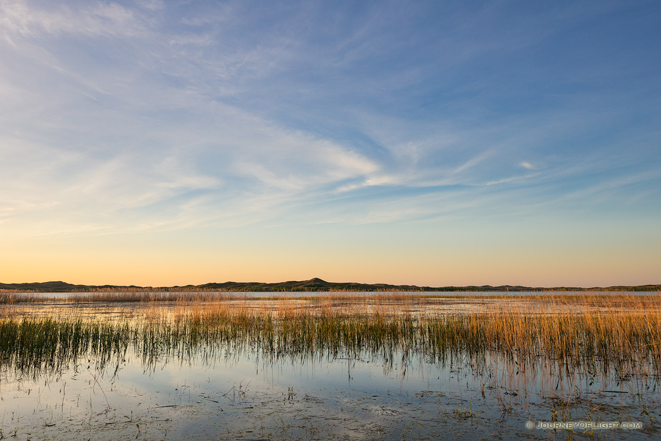 On a cool spring evening, sunset falls over Willow Lake nestled deep in the Sandhills of Nebraska. - Nebraska Picture