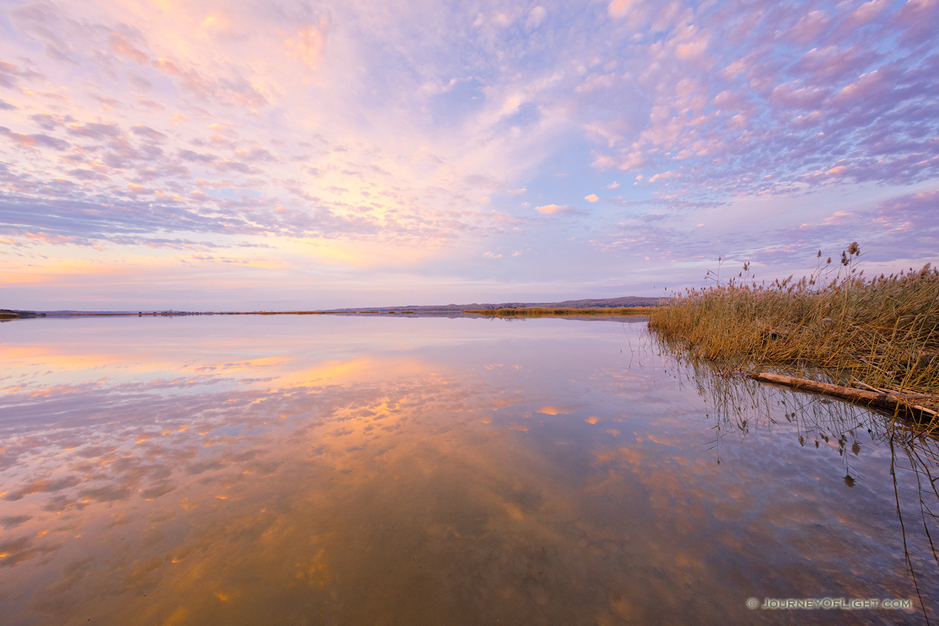 A beautiful sunset is reflected in the waters of the Missouri River at Niobrara State Park on the border of Nebraska and South Dakota. - Nebraska Picture