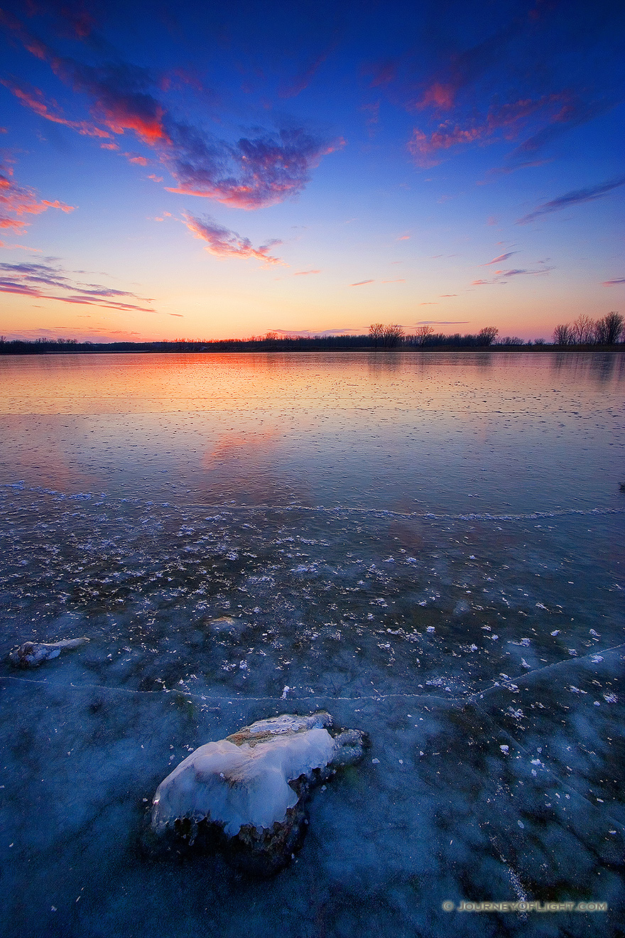 This photograph was captured in the dead of winter, when the old Missouri River oxbow at DeSoto National Wildlife Refuge transforms into a reflective sheet of ice with a single rock still visible. - DeSoto Picture