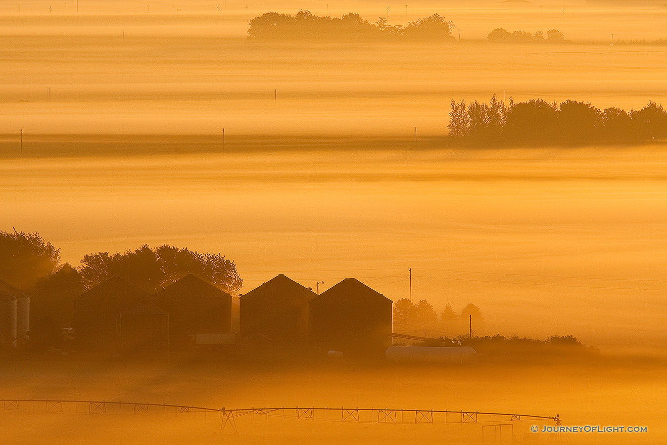 Sunlight grazes the fog as it rolls through the countryside across the Missouri from the Scenic Overlook at Ponca State Park in Dixon County. - Ponca SP Picture