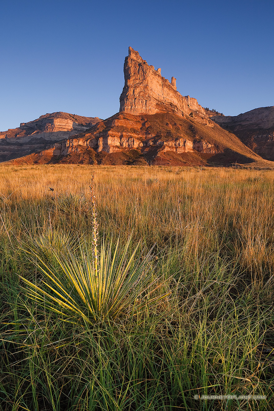 Scotts Bluff National Monument in western Nebraska.  Towering eight hundred feet above the North Platte River, Scotts Bluff has been a natural landmark for many peoples, and it served as the path marker for those on the Oregon, California, Mormon, and Pony Express Trails.  Scotts Bluff National Monument preserves 3,000 acres of unusual land formations which rise over the otherwise flat prairieland below. - Nebraska Picture