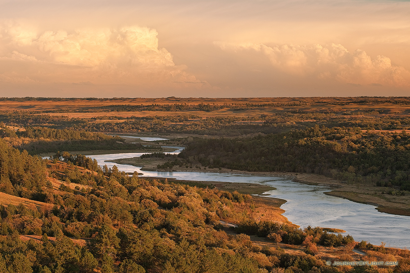 Storm clouds hover over the snaking Niobrara River near sunset in Keha Paha County in north central Nebraska. - Nebraska Picture