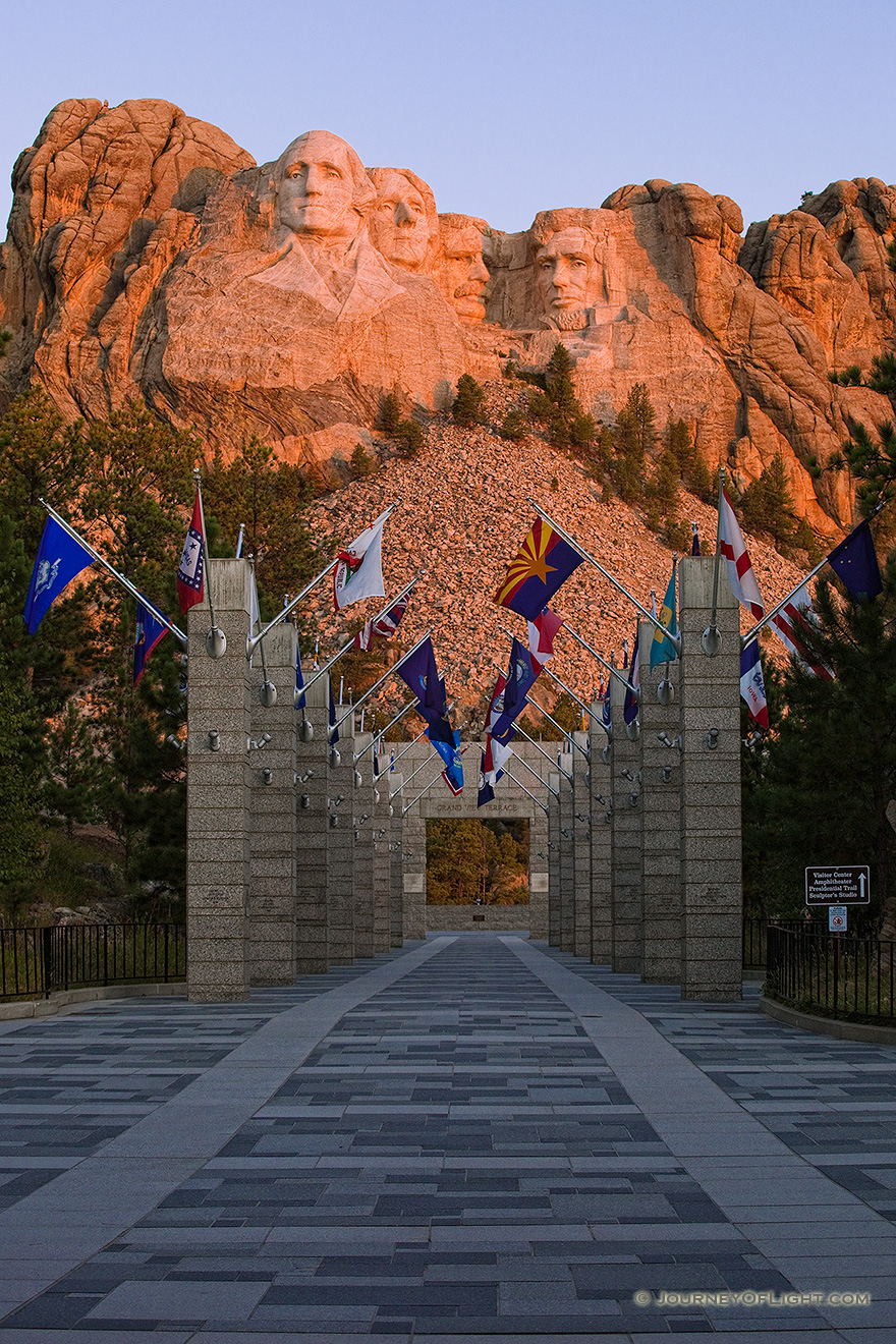 Mt. Rushmore National Monument at sunrise with the Avenue of Flags in the Black Hills of South Dakota. - Mt. Rushmore NM Picture