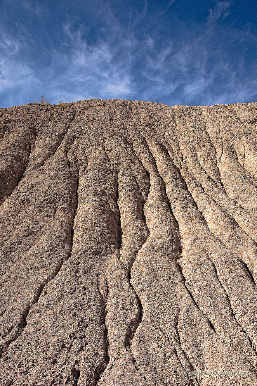 Clouds float lazily over the eroded hills at Toadstool Geologic Park. - Toadstool Picture