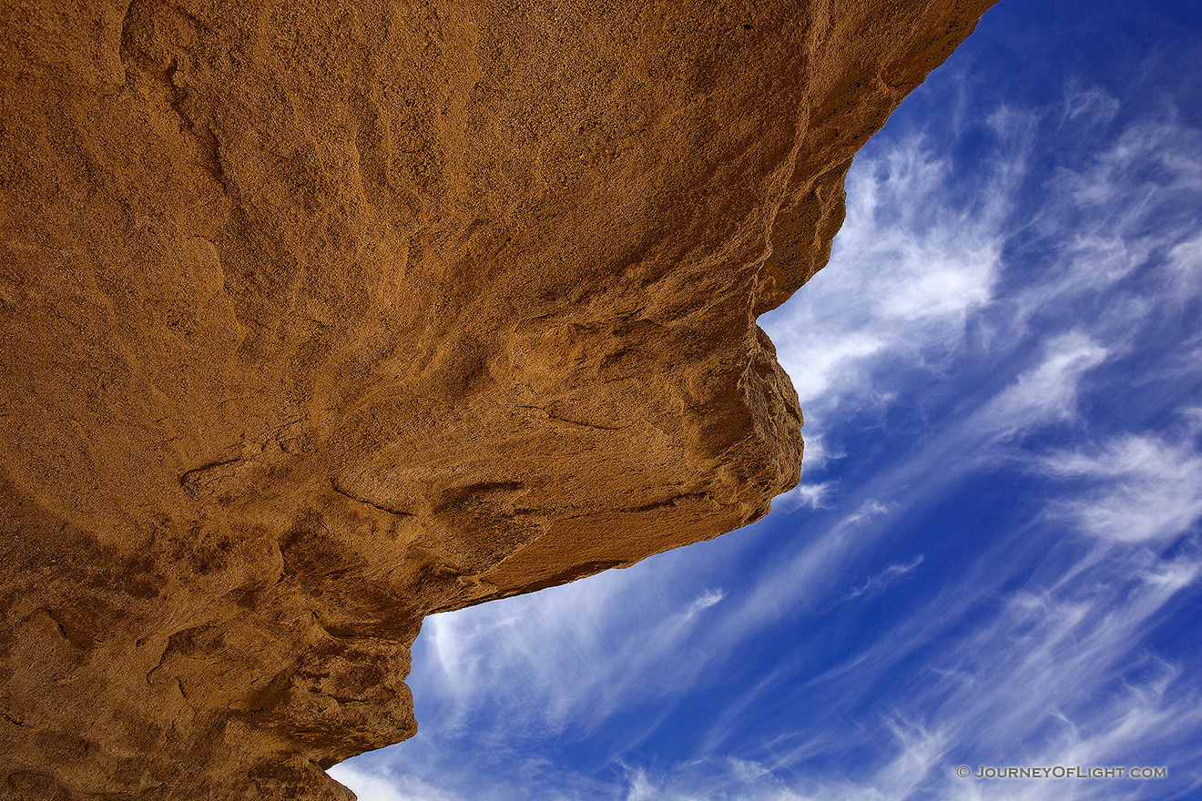 Clouds float lazily over the strange stone structures at Toadstool Geologic Park. - Toadstool Picture