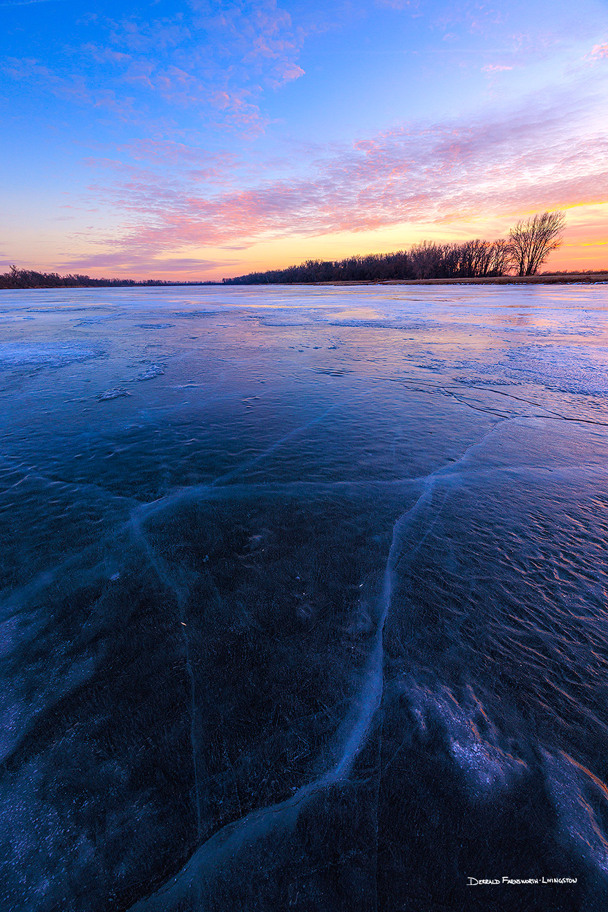 A scenic landscape photograph of the sunset over the frozen lake at DeSoto NWR, Nebraska. - Nebraska Picture