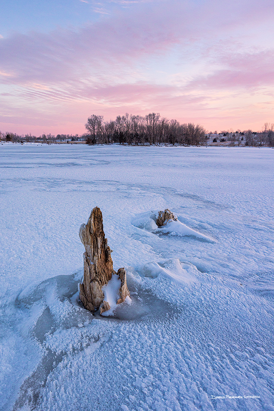 A scenic landscape photograph of purple clouds over the frozen lake at Walnut Creek, Nebraska. - Nebraska Picture