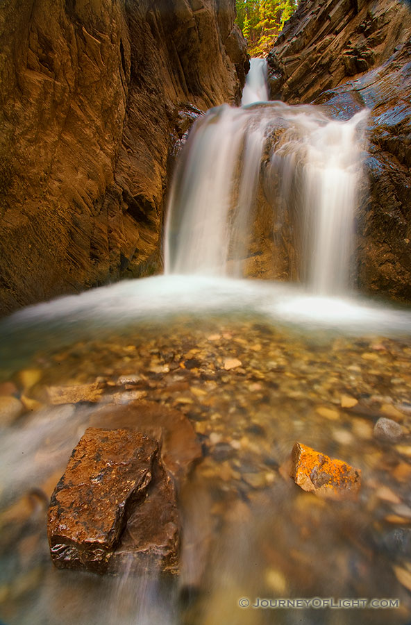 In the backcountry of the Kootenay Plains a hidden White Goat Falls cascades down a mountain side. - Canada Photography