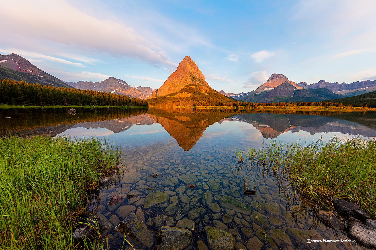 A scenic landscape photograph of sunrise on Swiftcurrent Lake, Glacier National Park, Montana. - Glacier Picture