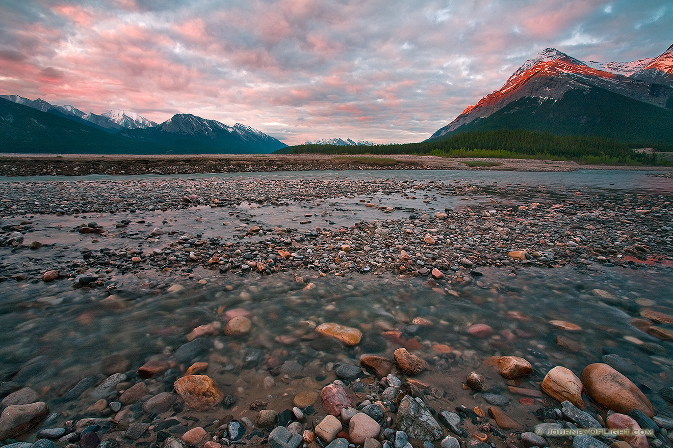 A cool breeze blows across the cool landscape as the morning sun briefly illuminates the peaks on the Kootenay plains. - Canada Picture